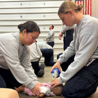 Dayton Fire Academy Trainees Performing CPR on a Doll Dayton Fire Academy trainees performing CPR on a doll.