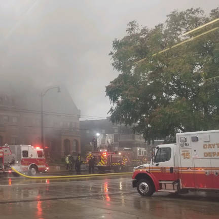 Fire Engines and Ambulance at Building Fire Fire engines and ambulance at building fire with smoke billowing out of the building.